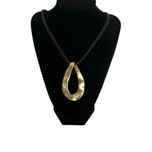 Reversible gold tone medallion necklace on black cord